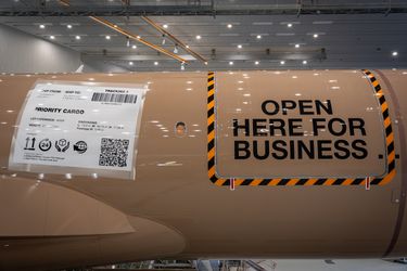 A350F fuselage in its cardboard-package livery, marked Open Here for Business