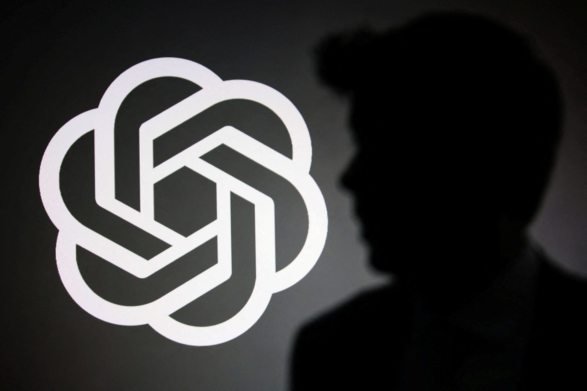 Illustration of Sam Altman silhouetted against an OpenAI logo