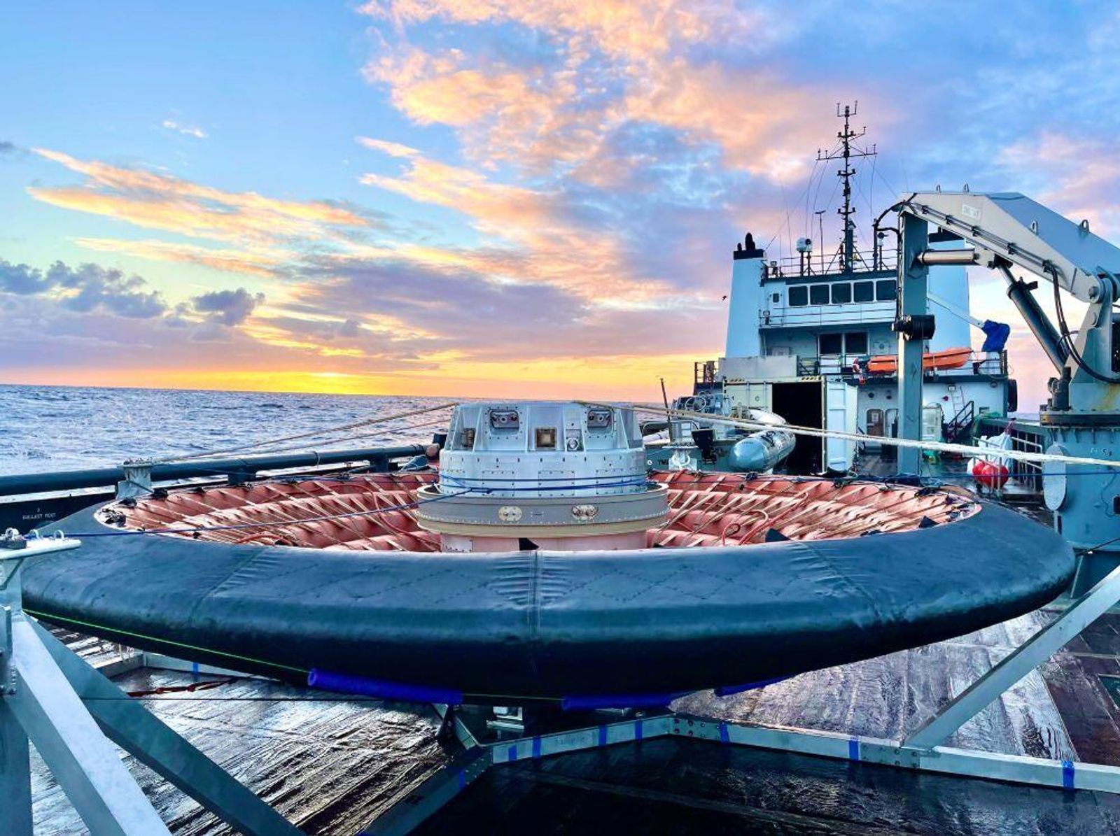 Vessel carrying space hardware at a waterfront facility, pictured in Aviation Week’s technology collaboration report