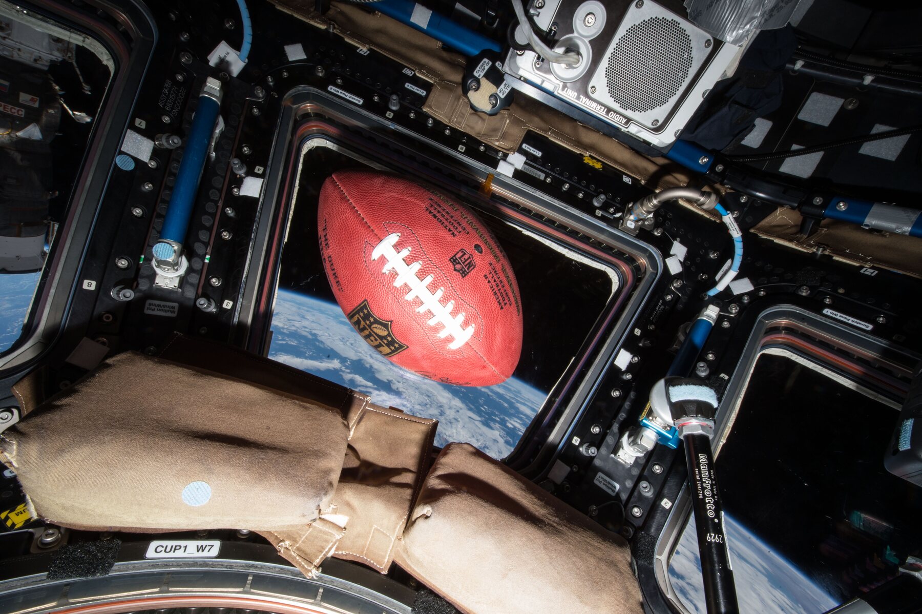 A football floating in microgravity inside the International Space Station